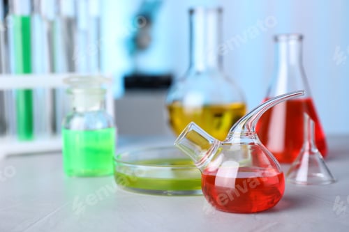 Preview: Laboratory glassware with samples on table indoors, space for text. Solution chemistry