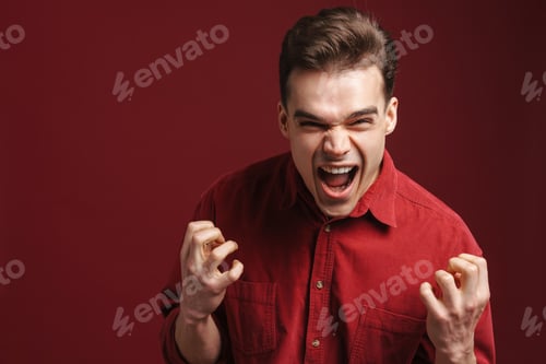 Preview: Young white man wearing shirt gesturing and screaming at camera