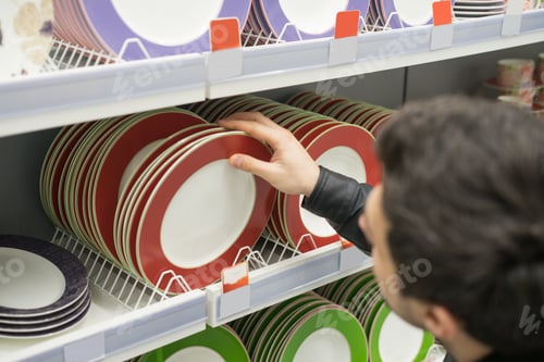 Preview: male customer choosing crockery plates