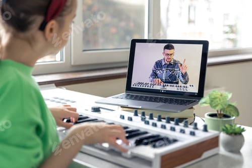 Preview: A girl learns to play the piano with a teacher online, remote learning music.