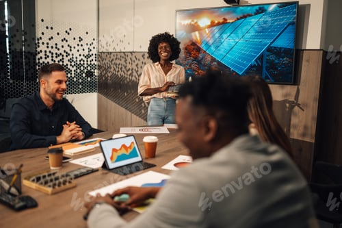 Preview: Happy diverse female expert with solar panel having lecture with team.