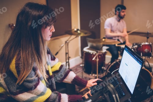 Preview: Woman sound engineer working in recording studio