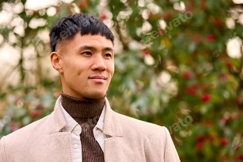 Preview: Smiling Young Man Wearing Coat Standing Outside In Autumn Or Winter Countryside