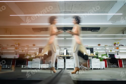 Preview: Professional business woman in motion with blur in business office