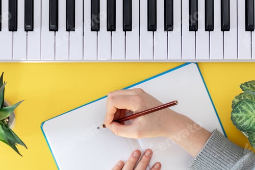 Preview: Piano keys with notepad close-up top view. Piano keys top view.