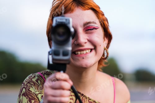 Preview: Teen girl holding vintage camcorder on movie shoot