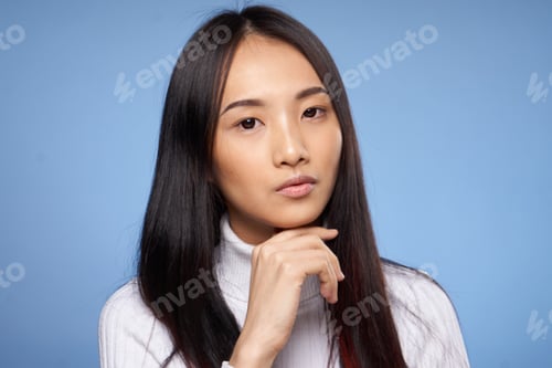 Preview: portrait pretty asian woman with dark hair white sweater blue background