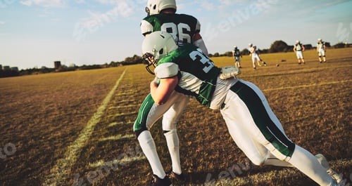 Preview: American football player tackling a pass receiver during practice