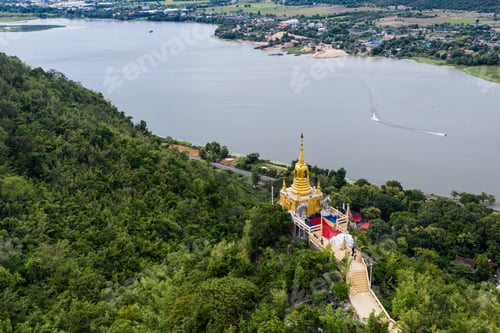 Preview: Golden pagoda on hill in tropical rainforest on Wat Ban Tham