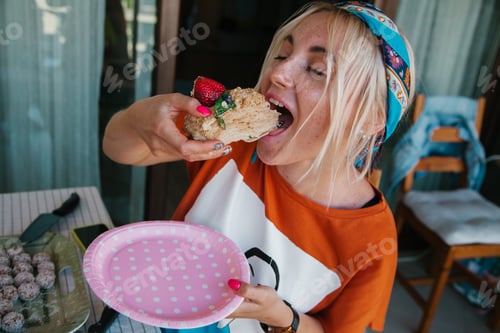 Preview: Portrait of Young blonde naughty girl eating cake