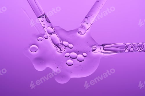 Preview: Transparent serum and several cosmetic pipettes on a lilac background. The texture.