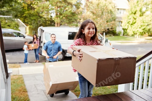 Preview: Children Helping Unload Boxes From Van On Family Moving In Day