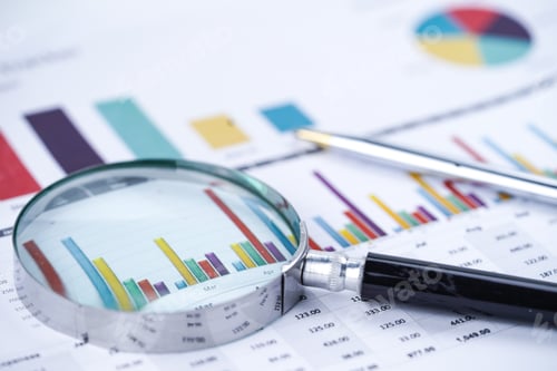 Preview: Magnifying Glass Examining Financial Data on Graphs