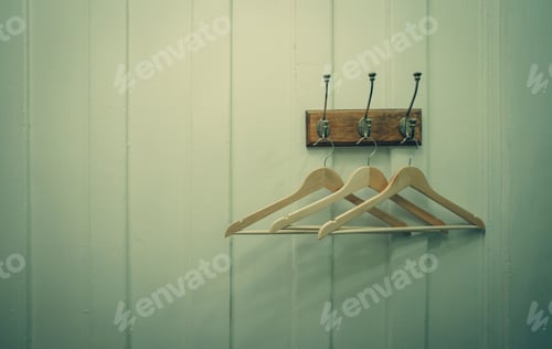 Preview: Three Wooden Clothes Hangers Hanging on Wall
