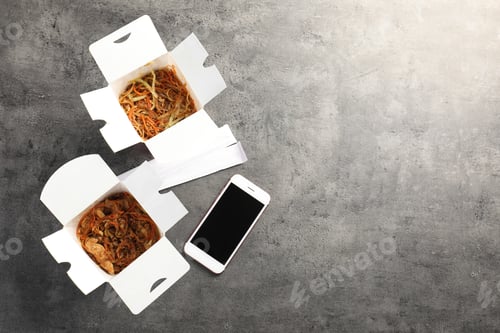 Preview: Smartphone with space for text and Chinese noodles on grey table, top view. Food delivery