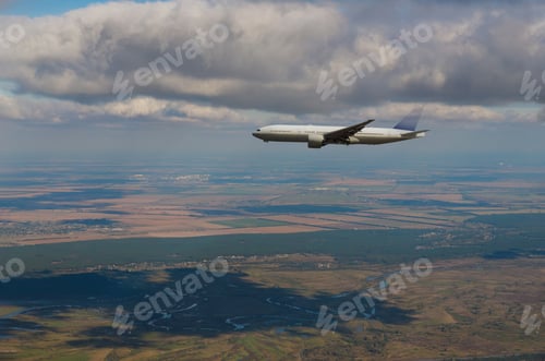 Preview: Airplane flying above away in the sky the view of the city