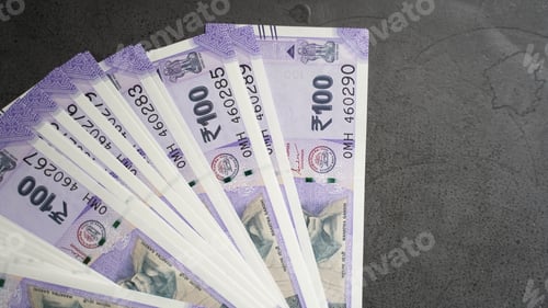 Preview: Overhead shot of cash money on a gray surface - finance concept