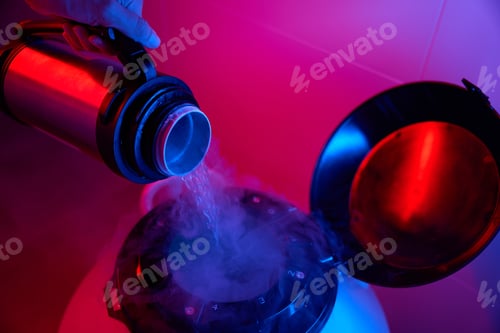 Preview: Laboratory employee pours liquid nitrogen into a cryocapsule