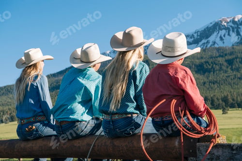 Preview: Rear view of cowboys and cowgirls on fence, looking away, Enterprise, Oregon, United States, North