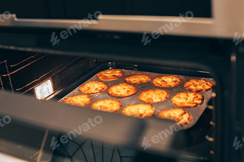 Preview: Homemade thanksgiving pumpkin pies in hot oven