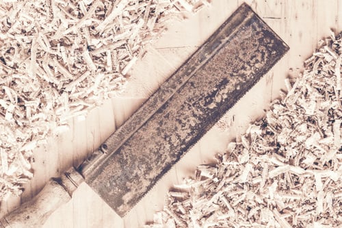 Preview: Carpenter tools on wooden table with sawdust. Carpenter workplace top view
