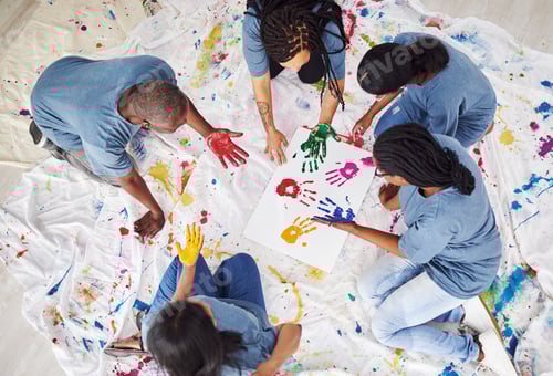 Preview: Shot of a group of people of people leaving painted handprints on a white poster
