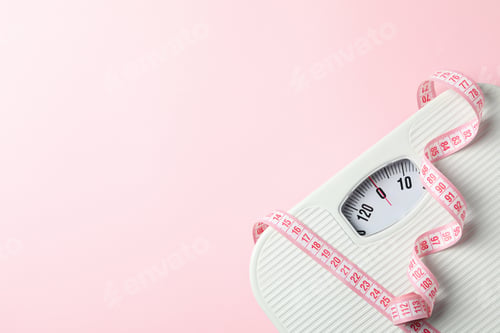 Preview: Scales and measuring tape on pink background. Weight loss concept