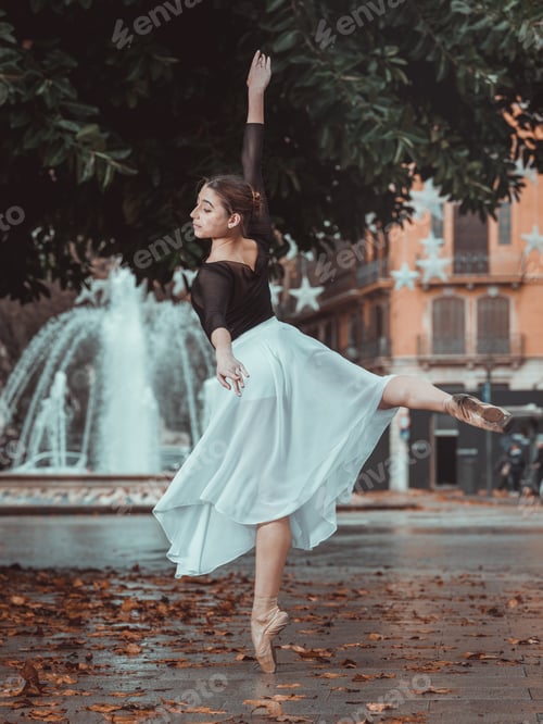 Preview: Young woman standing on tiptoe on street