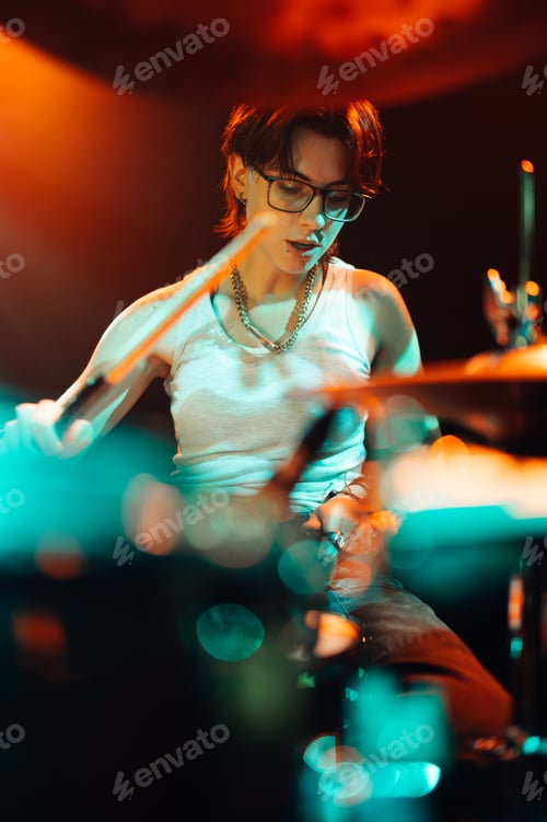 Preview: Drummer playing drums on stage with colorful lighting
