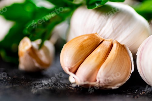 Preview: Fragrant garlic with parsley on the table.