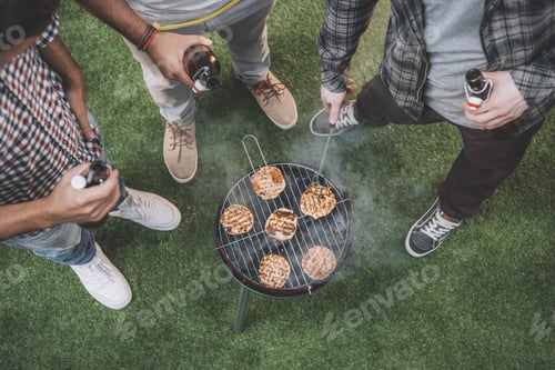 Preview: top view of young friends drinking beer and making barbecue