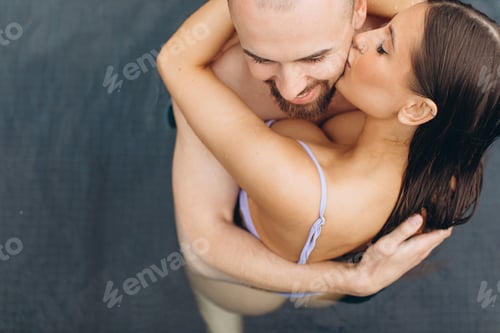 Preview: Couple in love swimming together in the pool
