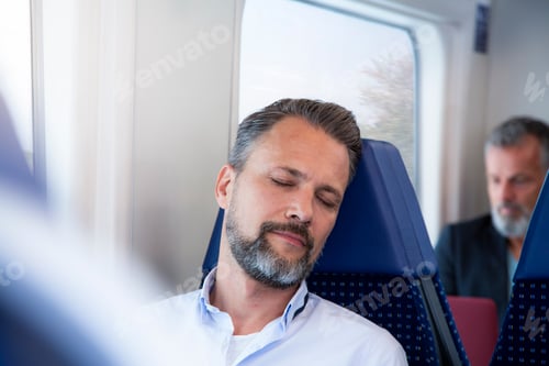 Preview: Mature man sitting in a train, sleeping