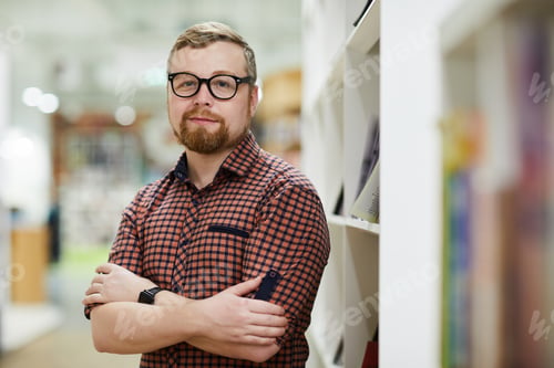Professional Man Posing Near Library Bookshelf