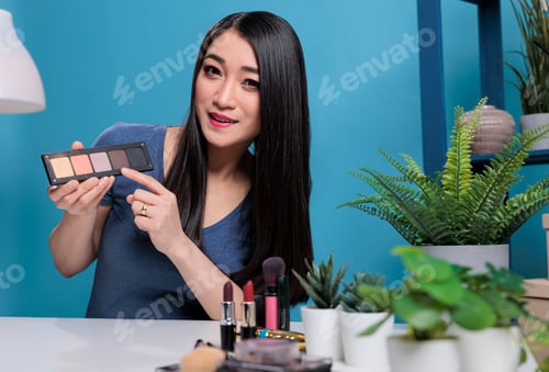 Preview: Social media influencer holding makeup palette filming creative tutorial