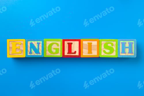 Preview: English. Wooden colorful alphabet blocks on blue background, flat lay, top view