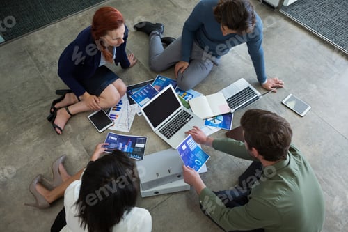 Preview: Business colleagues discussing over graph document