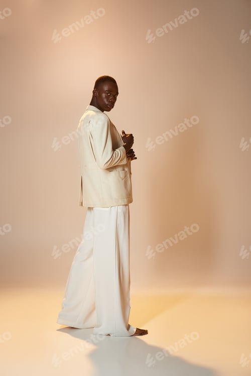 Preview: Stylish young african american man showcasing vibrant fashion in a creative studio setting