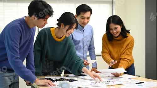 Preview: Group of young developers working on new website wireframe at creative office.