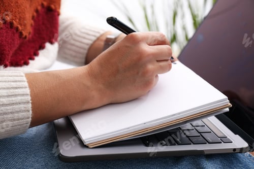 Preview: Goal plan in notebook with laptop on table