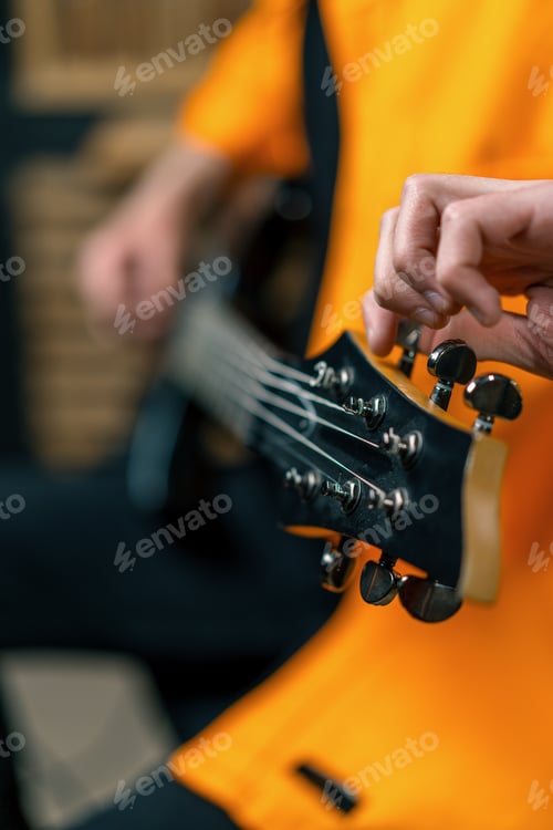 Preview: rock performer with electric guitar in recording studio recording playing own track