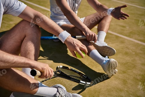 Preview: Two men enjoying a summer day on the tennis court with friendly competition