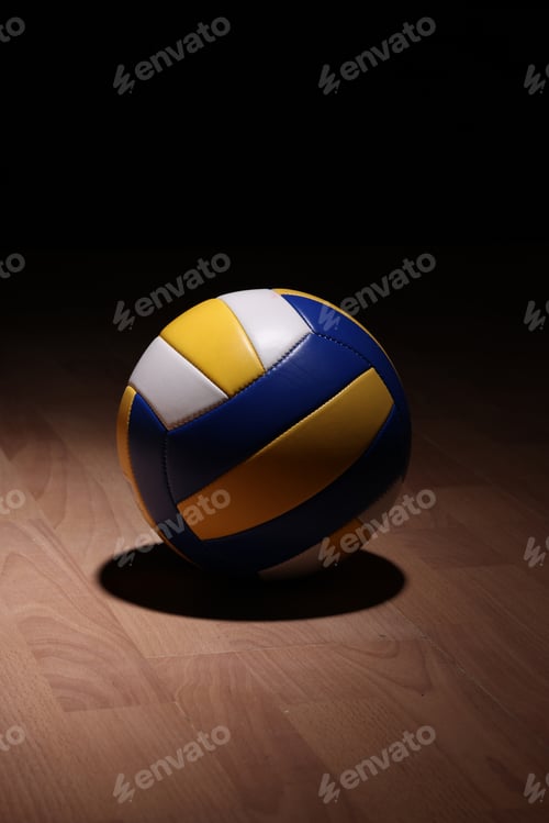 Preview: Volleyball on Wooden Court Floor Corner close up with light reflection with room
