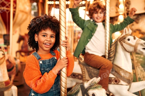 Preview: Kids having fun on a carnival Carousel