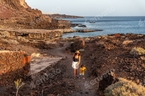 Preview: Mother and son on a footpath at sunset on Tacoron beach on El Hierro, Canary Islands