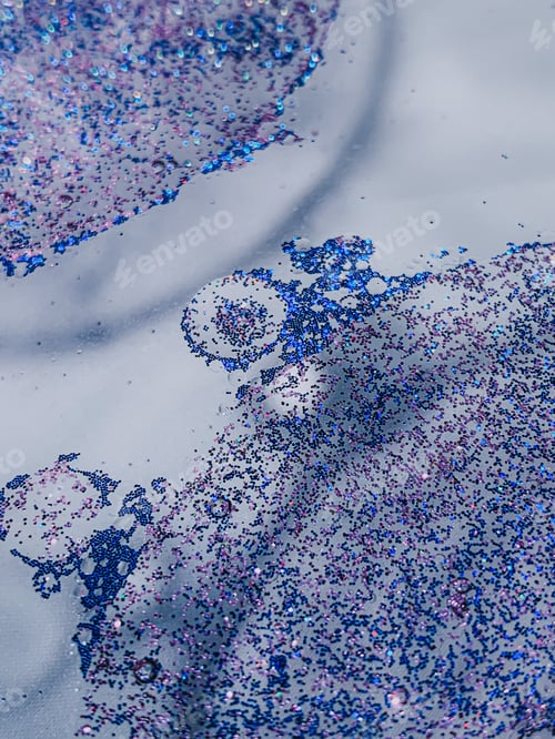 Preview: Vertical shot of blue and purple glitter and waterdrops