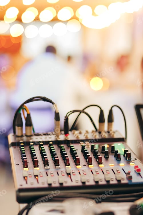 Preview: Sound mixer close-up with glowing lights on background, party