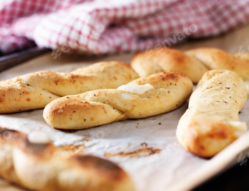 Preview: baked mozzarella breadsticks on parchment paper