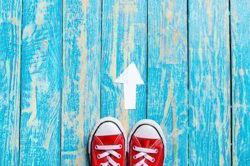 Preview: red sneakers on wooden background.