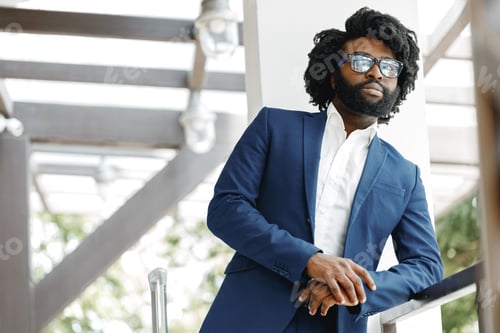 Preview: Portrait of african american businessman standing in hotel lobby